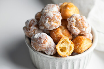 Bunuelos, Spanish Small  deep fried doughs on ceramic ball on white background.Close up