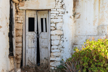 View of the facade of a ruined building in Chora. Folegandros Island, Greece.