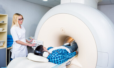Radiologist prepares the patient for an MRI knee examination