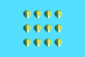 Brussels sprouts seamless pattern. Pop art cabbage pattern. Abstract background with small cabbage. Colorful vegetable pattern of green cabbage. Heart-shaped cabbage. Vegan love.