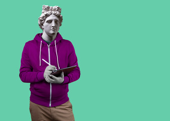 Modern art collage. Concept portrait man holding tablet and pencil. Gypsum head of Apollo.