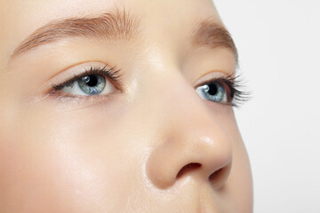 Naklejka premium Closeup shot of human teenager girl face. Young female with natural face and eyes beauty makeup