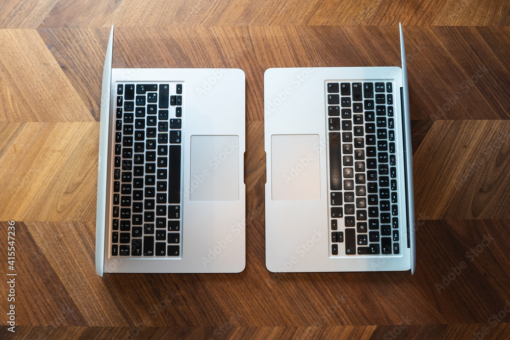 Wall mural two laptops facing eachother on table