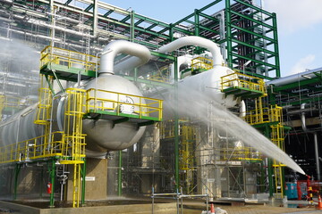 Water flowing vigorously from open fire hydrant as part of the fire extinguishing system testing...