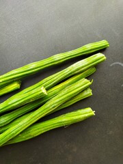 moringa oleifera isolated on black surface, closeup