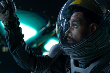 Portrait of African American Black male astronaut inside spaceship cockpit. Sci-fi space...