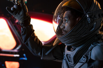 Portrait of African American Black male astronaut inside spaceship cockpit. Sci-fi space exploration concept. Mars mission © supamotion