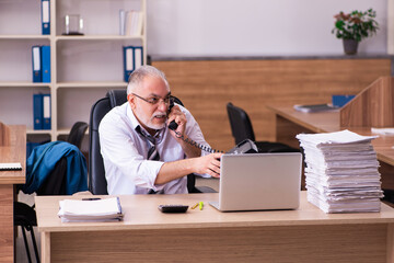 Old male employee unhappy with excessive work in the office