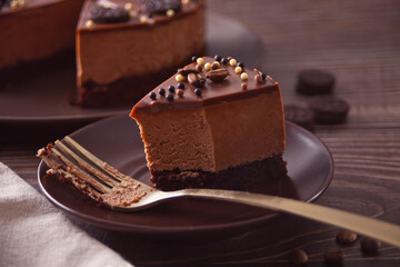 chocolate cheese cake on the wooden table with fork