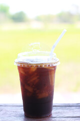 Iced americano coffee with ice on table at cafe.