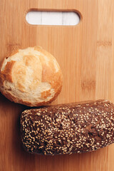 rye loaf on a wooden board top view soft bun