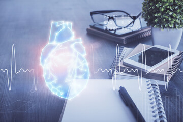 Double exposure of human heart drawing and cell phone background. Concept of medical education