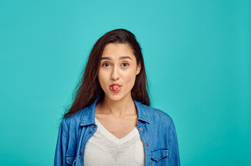 Fototapeta premium Cute woman shows her tongue, positive emotion