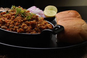 Masala Anda Bhurji or Spicy Indian scrambled eggs with bread or Bun Pav, Popular street food