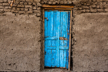 Colourful exterior wall of a Nubian house in Egypt. Typical African village houses facade. Medieval street.