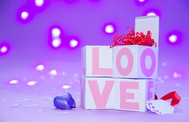 Boxes with love on the background of lights, pink love. Candy and gifts to your loved ones.