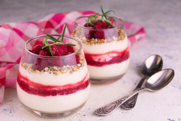 Two desserts with raspberries and cream cheese on a white background. Healthy homemade organic dessert.