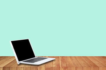 A laptop computer on a wooden floor