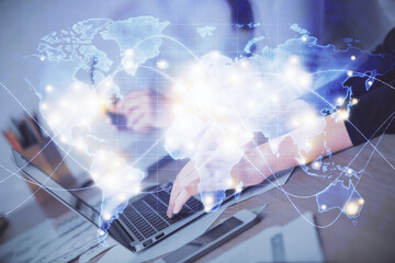 Obraz premium Multi exposure of woman hands typing on computer and business theme hologram drawing. Success concept.