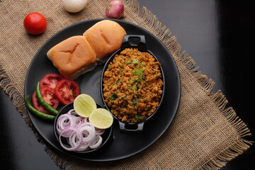Masala Anda Bhurji or Spicy Indian scrambled eggs with bread or Bun Pav, Popular street food