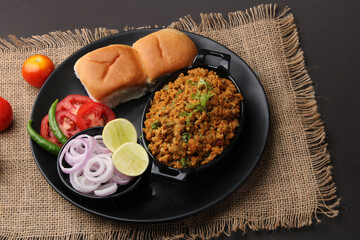 Masala Anda Bhurji or Spicy Indian scrambled eggs with bread or Bun Pav, Popular street food
