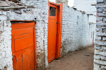 Colourful exterior wall of a Nubian house in Egypt. Typical African village houses facade. Medieval street.