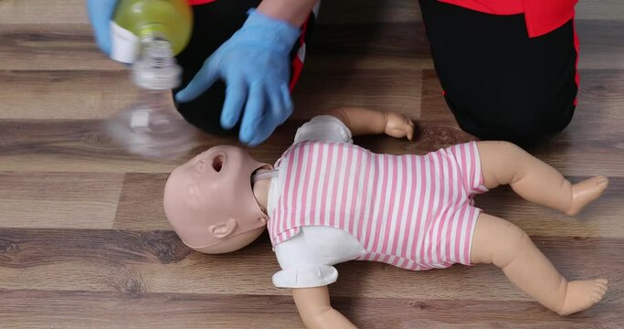 Giving first aid on a child dummy. Practitioners training medical learning on a baby mannequin. Emergency course for resuscitation. First aid training.