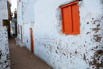 Colourful exterior wall of a Nubian house in Egypt. Typical African village houses facade. Medieval street.