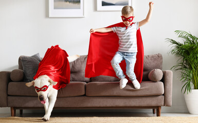 Happy kid and dog in Superhero outfits having fun at home