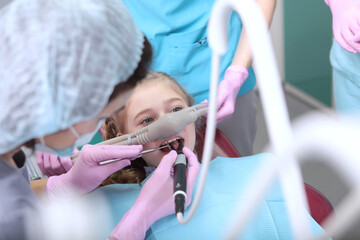Inhalation of nitrous oxide in dentistry. A little girl at a dentist's appointment. Relaxation of...