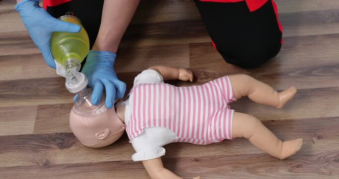 Giving first aid on a child dummy. Practitioners training medical learning on a baby mannequin. Emergency course for resuscitation. First aid training.