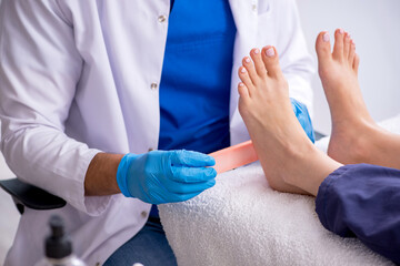 Podiatrist treating feet during procedure