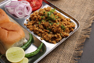 Fototapeta na wymiar Masala Anda Bhurji or Spicy Indian scrambled eggs with bread or Bun Pav, Popular street food
