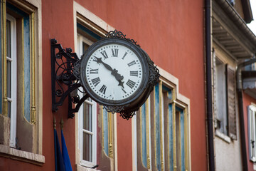 Fototapeta na wymiar Closeup of retro clock on building facade in the street