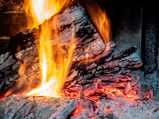 Burning billets in fireplace as abstract background