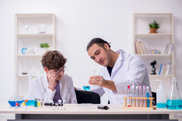 Young father and son chemists in the lab