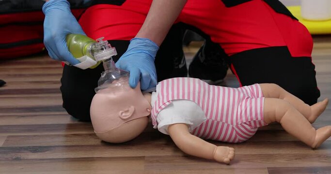 Giving first aid on a child dummy. Practitioners training medical learning on a baby mannequin. Emergency course for resuscitation. First aid training.