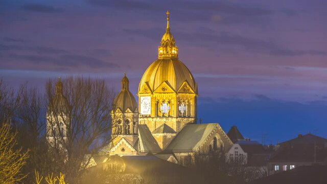 Muncih sant lukas church at night time lapse after sunset, munich cityscape.