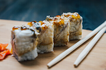 sushi chopsticks ginger red on a wooden board snack