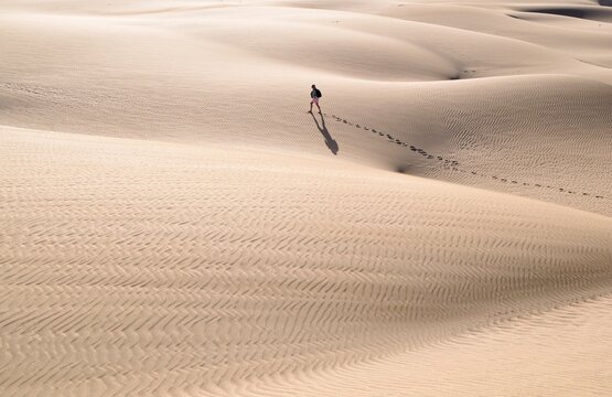 Landscape photo of person walking in desert