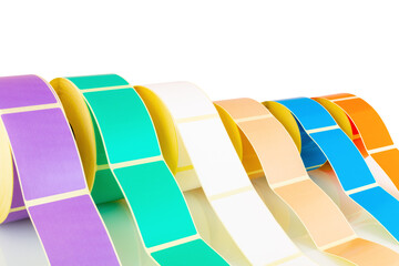 White and colored label rolls isolated on white background with shadow reflection. Color reels of...