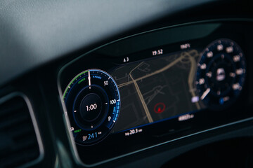 Modern electric car close up view of tachometer and dashboard with backlight