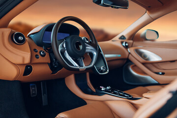 Modern supercar interior with leather panel, sport seats, multimedia and digital dashboard