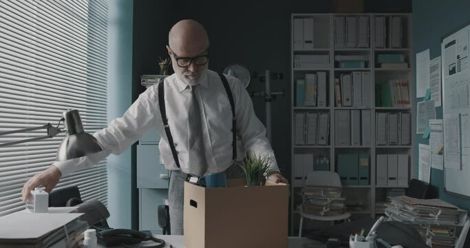 Employee packing his belongings and leaving the office
