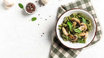 Mushroom and Spinach Pasta in a Bowl, Vegan Food on light background. banner, menu recipe place for text, top view