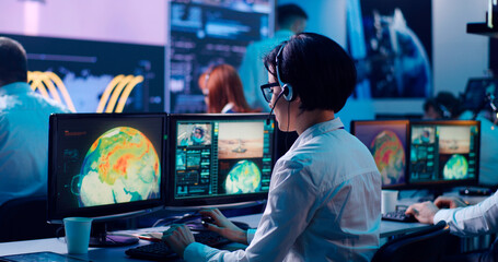 Team watching rocket launch in office