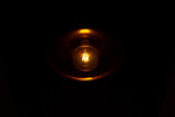 light bulb in the dark, light bulb on black background