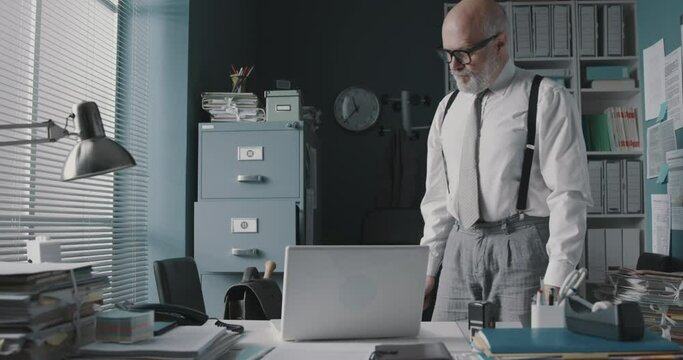 Angry businessman destroying his laptop