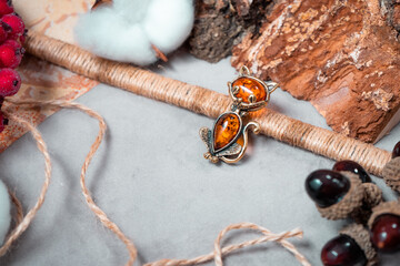 A brooch in the form of a Cheshire cat made of bronze and amber