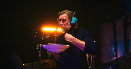 Man eating and talking while recording movie soundtrack